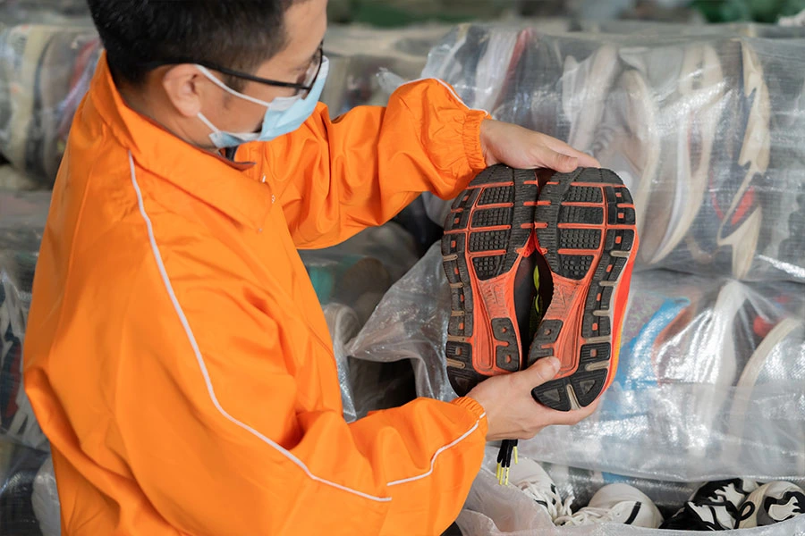 Workers inspecting shoe quality and condition