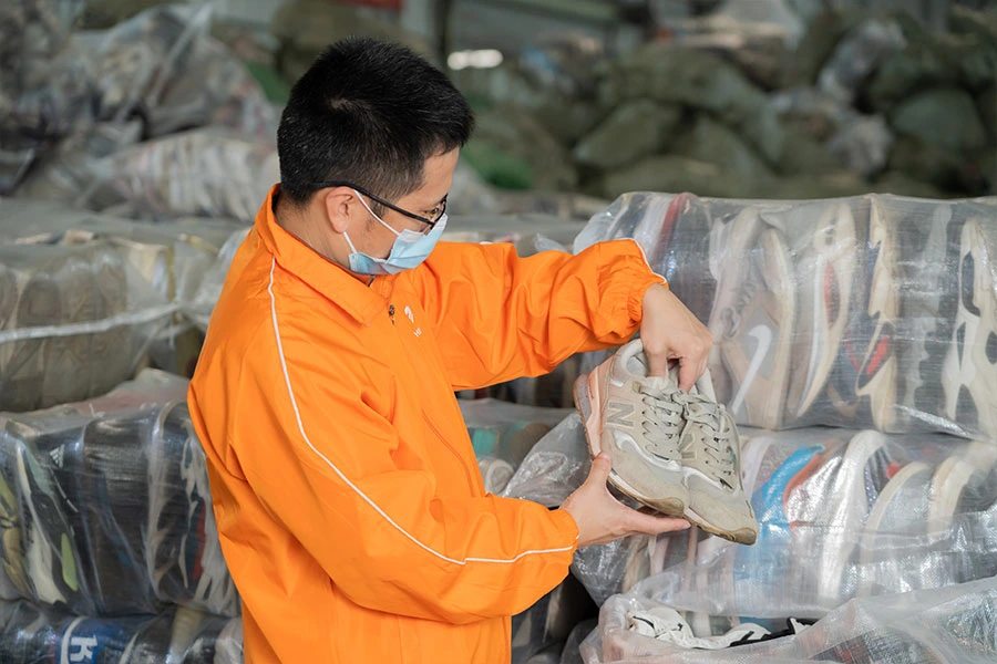 employee inspecting secondhand sneakers