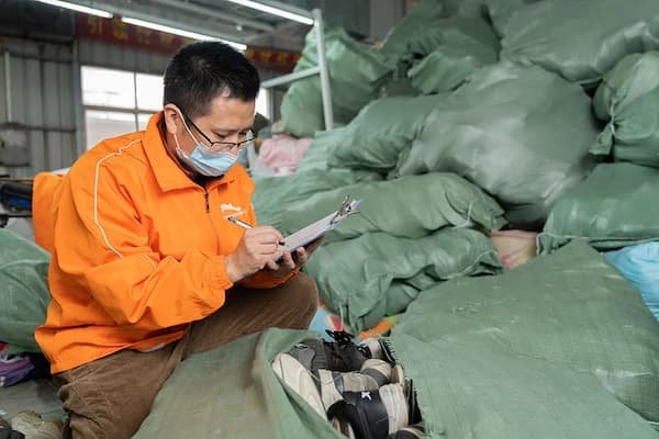 auditor checks all incoming used shoes