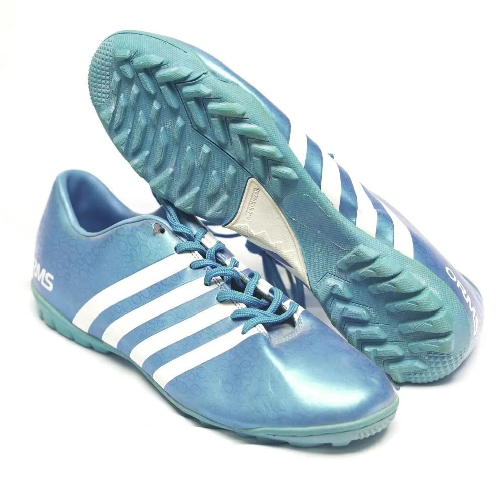 Used football sneakers in a shade of turquoise in excellent condition