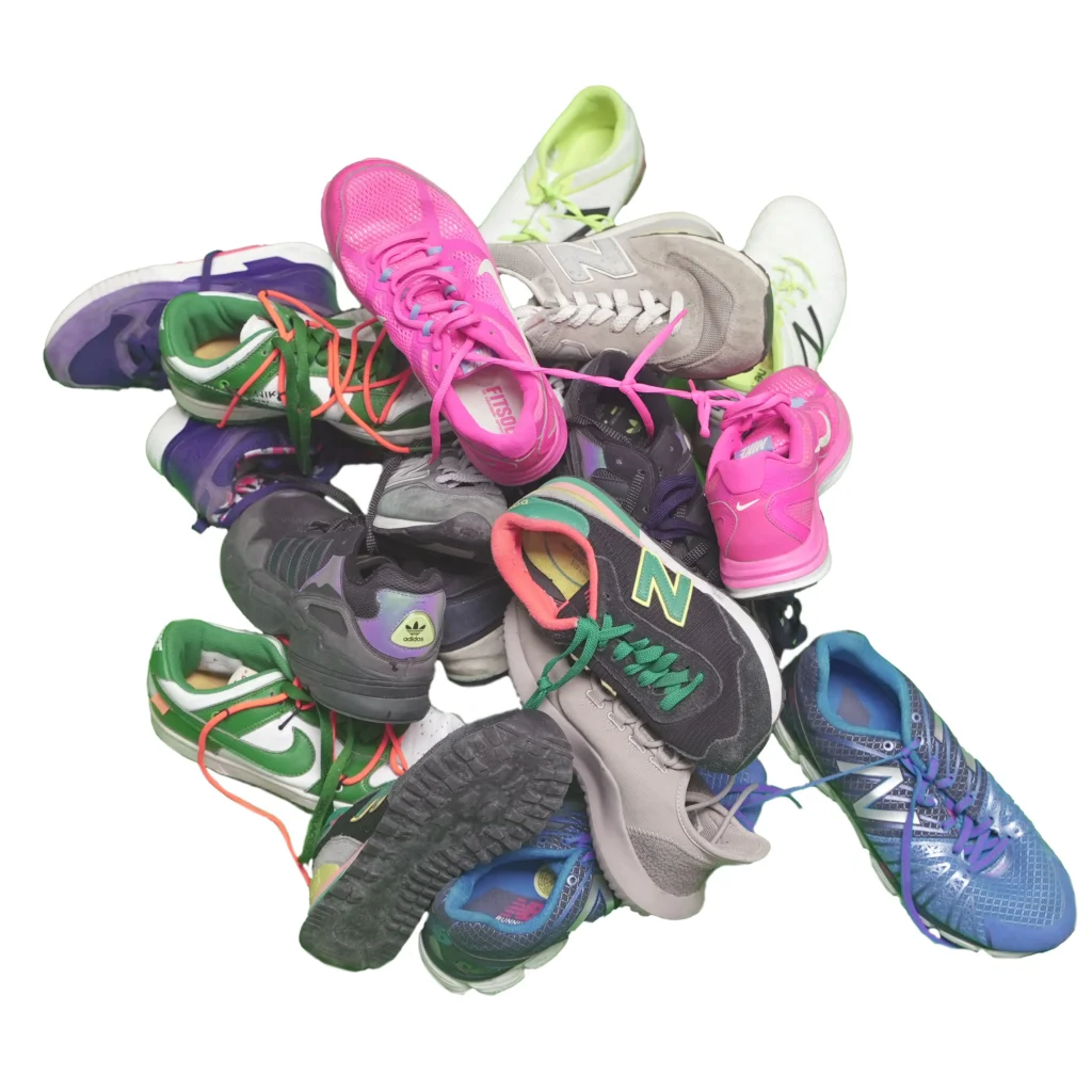 a pile of assorted used women sneakers